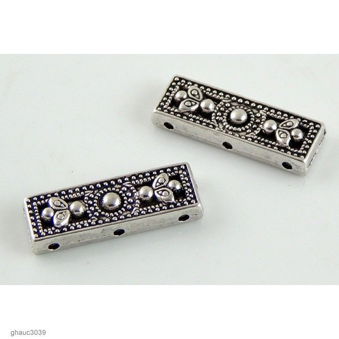 Antique-silver plated zinc alloy, Bali-Thai style flat, 3-hole spacer bars.  Each bead measures 26mm end-to-end.